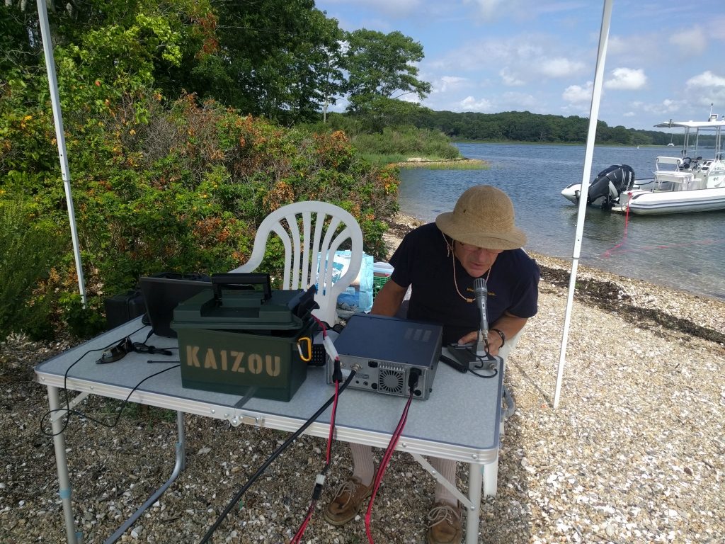 Jim, KA1ZOU, at the operating position on Gardner Island, RI (Note Goblin in background)
